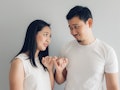 Sulk and reconcile Asian couple lover in white t-shirt and grey background.