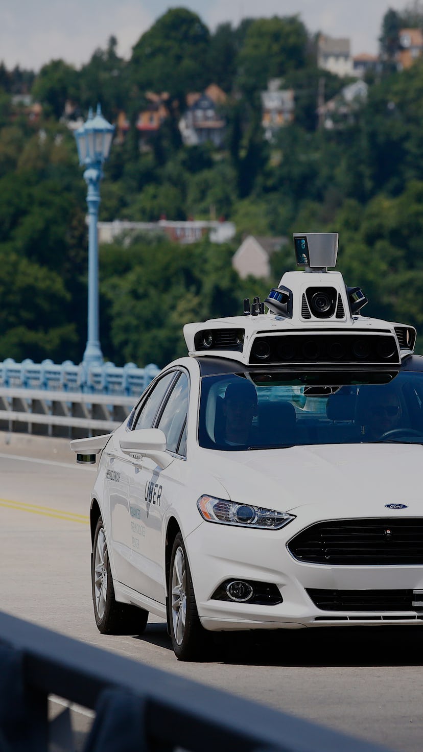 Uber employees test a self-driving Ford Fusion hybrid car, in Pittsburgh. Uber said that passengers ...