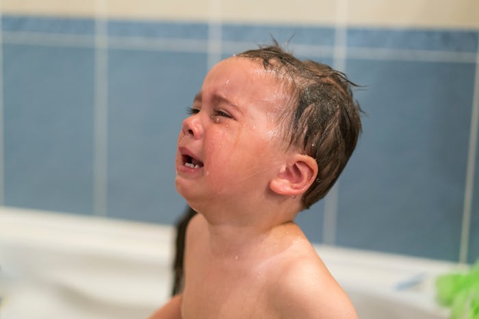 Crying baby boy in the bathtub