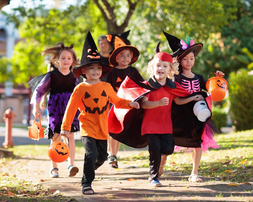 Kids on halloween in an article about how to let trick-or-treaters know you've got candy.
