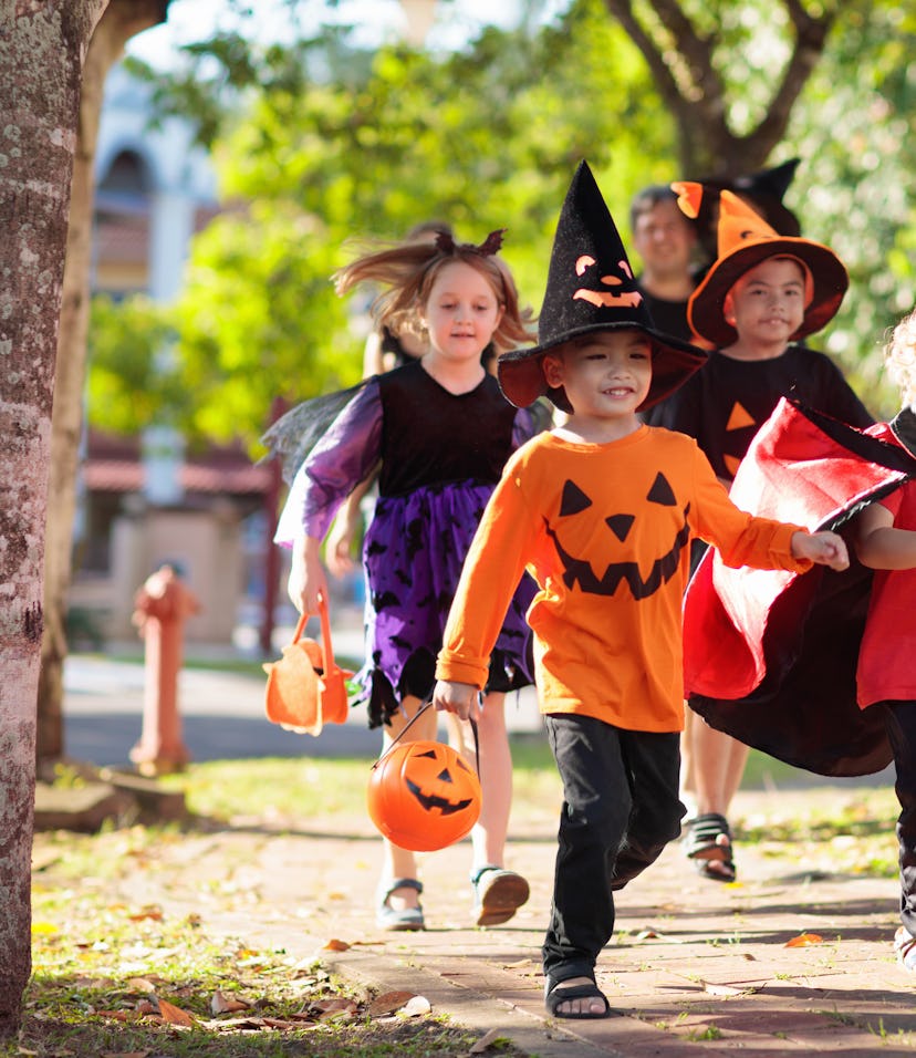 Kids on halloween in an article about how to let trick-or-treaters know you've got candy.