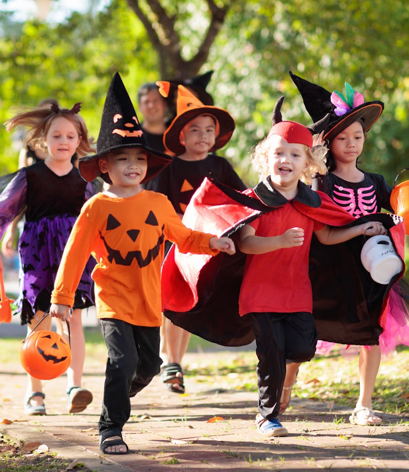 Kids on halloween in an article about how to let trick-or-treaters know you've got candy. 
