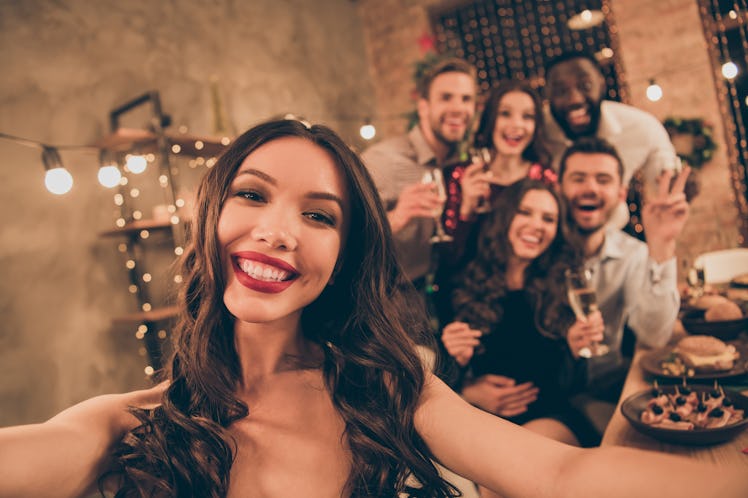 Close up photo of cheerful lovers celebrate xmas christmas party make selfie gather around table wit...