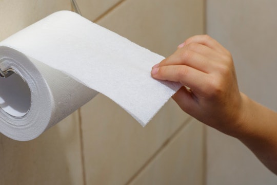 A child tears off toilet paper. Indigestion in children