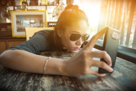 Asian woman is holding her smartphone with feeling of sadly, lonely,and confusingly.Locating on the ...