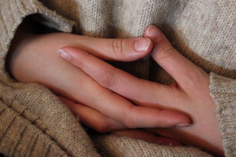 Hands clasped together in tension in a waiting room. A BRCA diagnosis can lead to mental health impa...