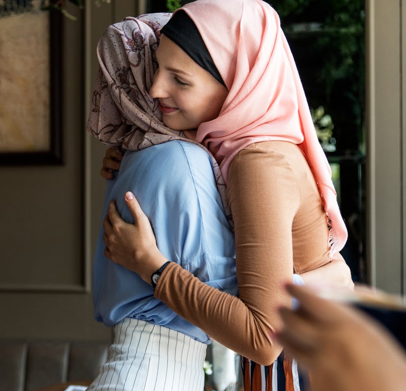 Islamic women friends hugging.