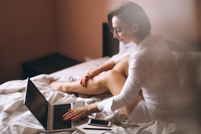 Woman in bed with computer business