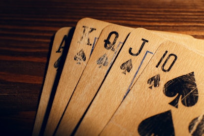 Playing cards on wooden table, closeup