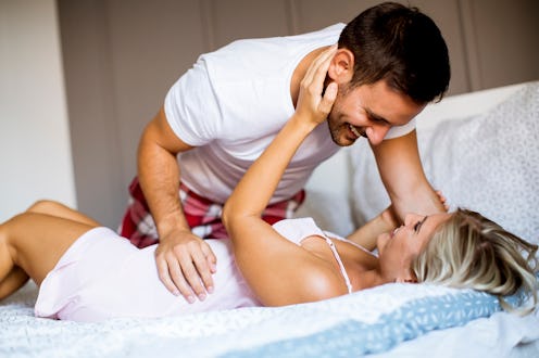 Lovely happy young couple in the bed