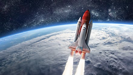 Space shuttle launch in the open space over the Earth. Ocean and sky under space ship. Elements of t...