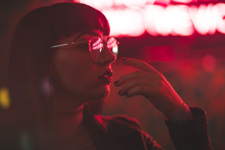 Girl with glasses in neon red lights