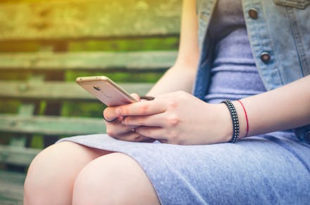 Girl texting on the phone in social networks. Internet. Long distance communication. Photo.