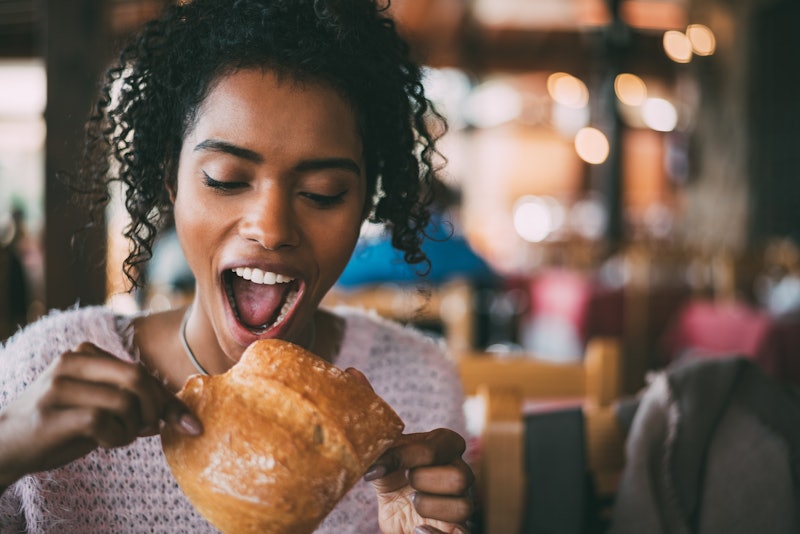 Black woman eating bread