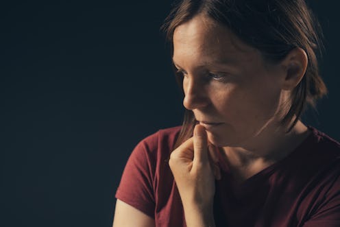 Low key portrait of depressed sad woman