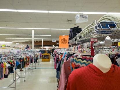 Affordable Used Clothing for Sale on hanging Racks at a Thrift or Resale Store