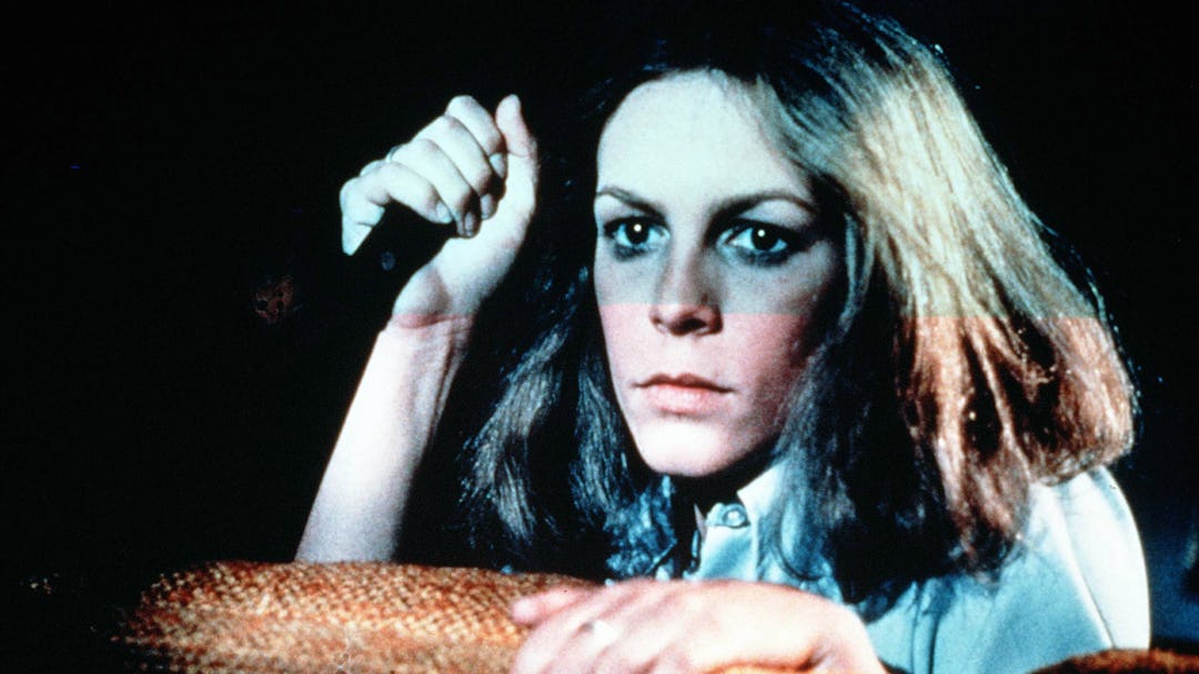 'Halloween' Film - 1978 -
Laurie Strode (Jamie Lee Curtis) looking over the top of a sofa with a...