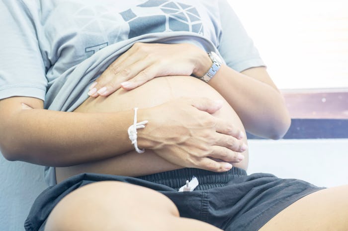 Pregnant women ate born with abdominal pain while sitting on a bed in the deliver room if the hospit...