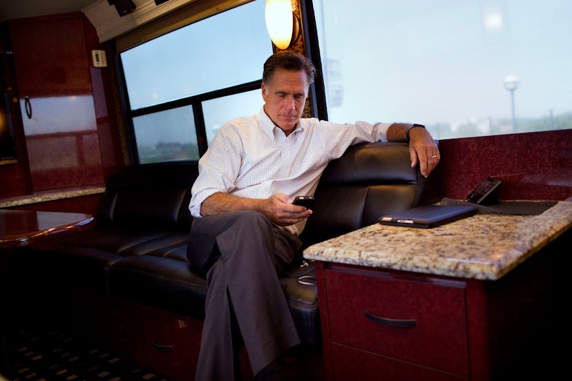 Mitt Romney Republican presidential candidate, former Massachusetts Gov. Mitt Romney check his phone...