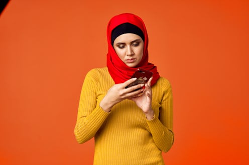 muslim woman looking into the phone