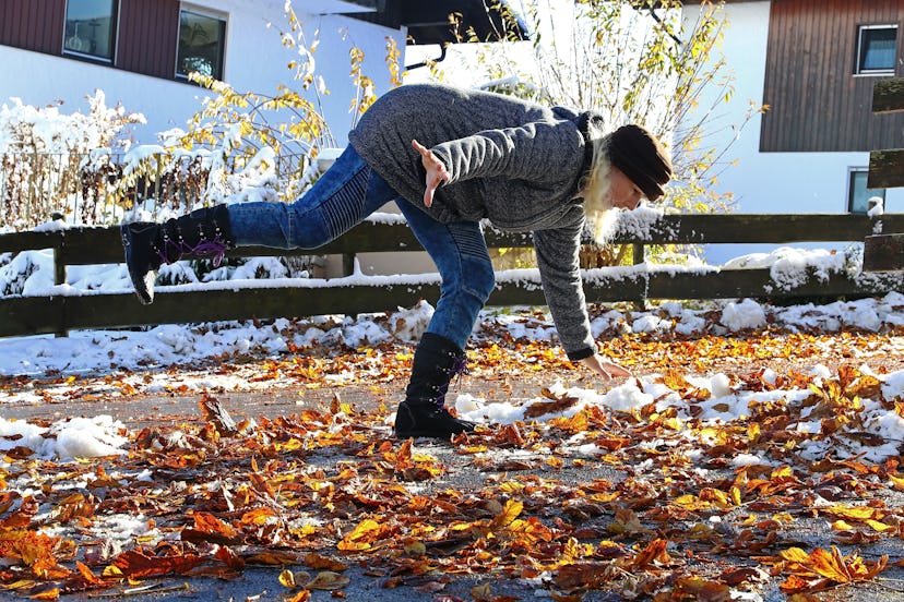 Risk of slipping in autumn and winter. A woman slipped on wet, smooth leaves.
