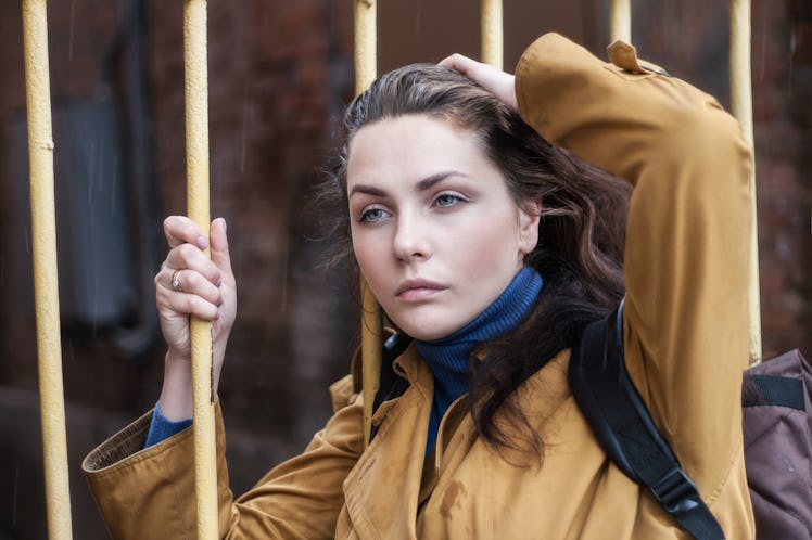 Portrait of a young sad woman outdoors closeup.