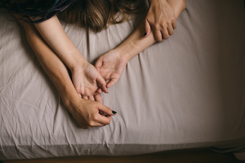 couple's hands in bed have sex. passion and love. sensual moment of intimacy