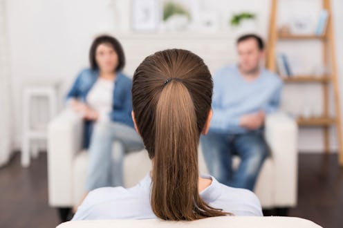 Professional female psychologist sitting opposite her patients