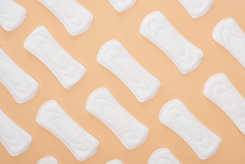 Pattern with white cotton sanitary towels isolated on beige