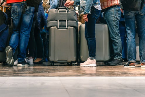 Passengers waiting in line for boarding an airport for a flight. Ever wonder why waiting in line is ...