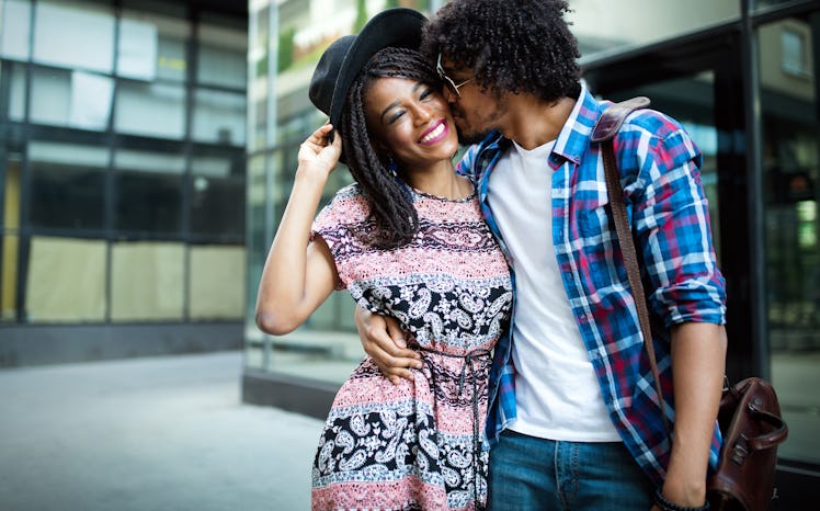 Young beautiful funny couple in love having fun outdoor on the street