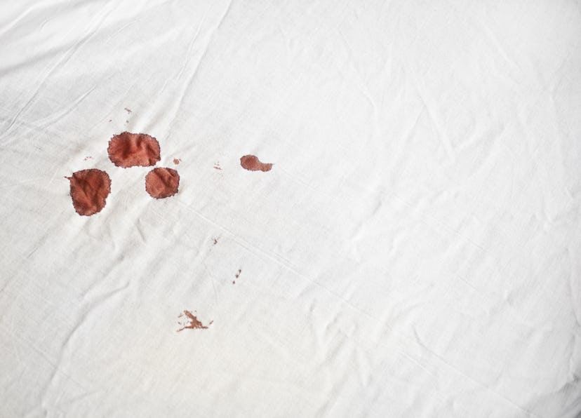Bloodstains on a white sheet. Here's the hormonal reason you get horny during your period