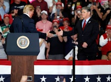 President Donald Trump shakes hands with Fox News Channel's Sean Hannity, right, during a campaign r...