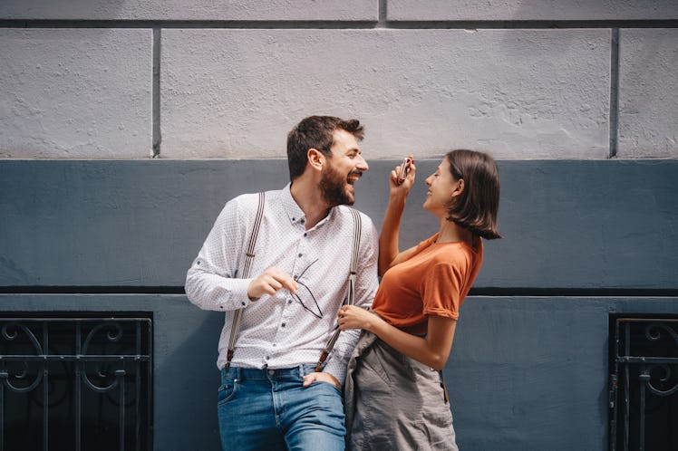 Young couple taking a photo with mobile phone.