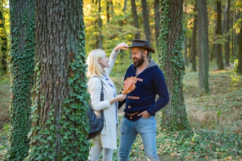 Young couple with autumnal mood. Passion dating and love. Autumn and leaf fall Dreams. Portrait of b...
