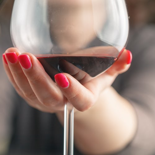 waitress pouring red wine in a glass