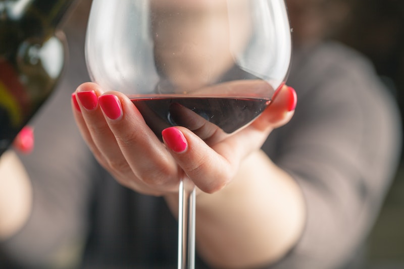 waitress pouring red wine in a glass