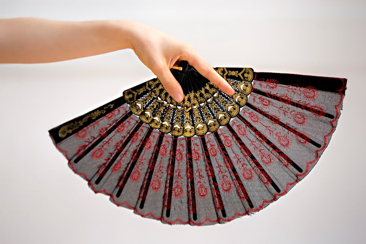 Female hand holding a fan 