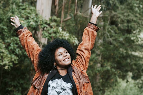young woman smiling happily in the forest outdoor
