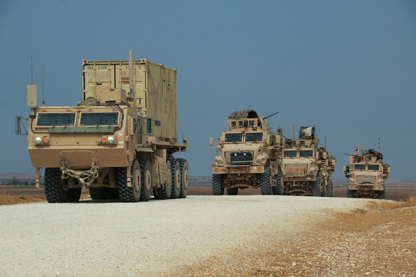 American military convoy stops near the town of Tel Tamr, north Syria, . Kurdish-led fighters and Tu...