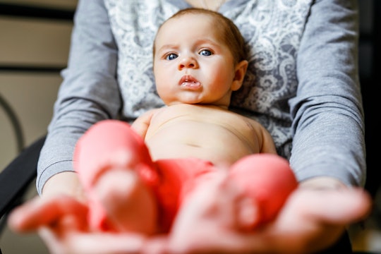 Mom with a newborn daughter on her lap on maternity leave