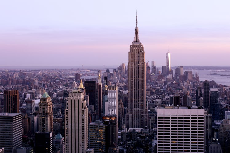 The sky is purple over the New York City skyline.