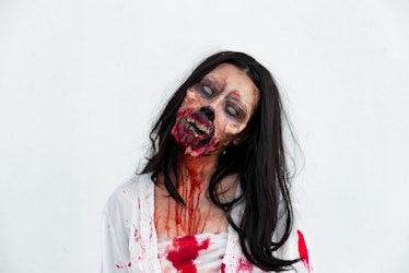 Portrait of asian woman make up ghost face with blood on white background,Horror scene,Scary backgro...