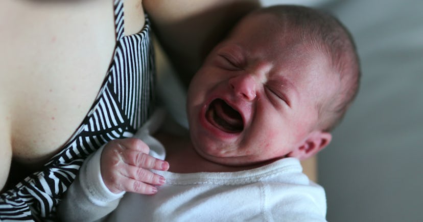 Newborn baby crying in mother arm