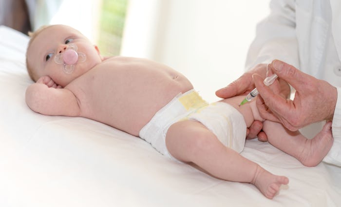 Little baby getting a vaccine shot in leg