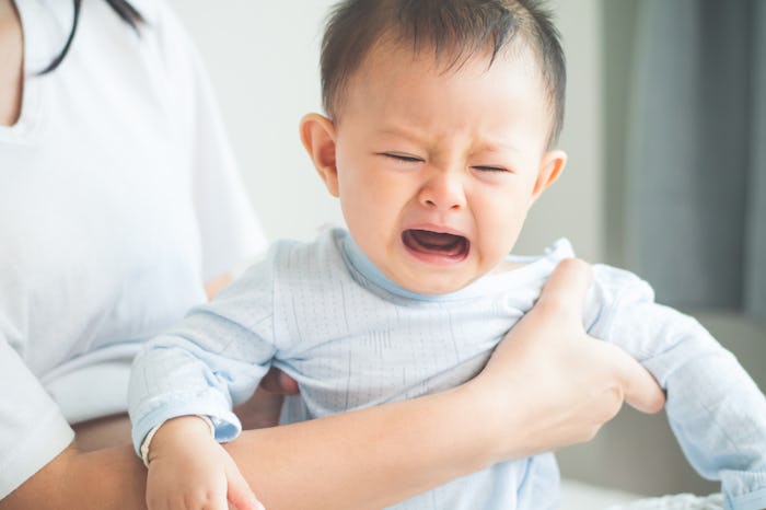 Crying baby in his mom's lap