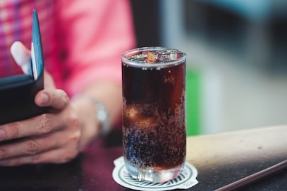 A soda with ice. Ingesting too much air can lead to passing gas too much