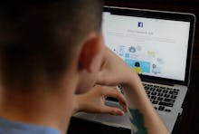 A man poses for photos in front of a computer showing a Facebook ad preferences page in San Francisc...