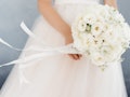 white bride's bouquet in the hands of the bride