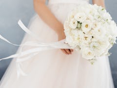 white bride's bouquet in the hands of the bride